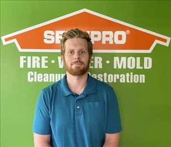 Photo of a man in front of a Servpro logo