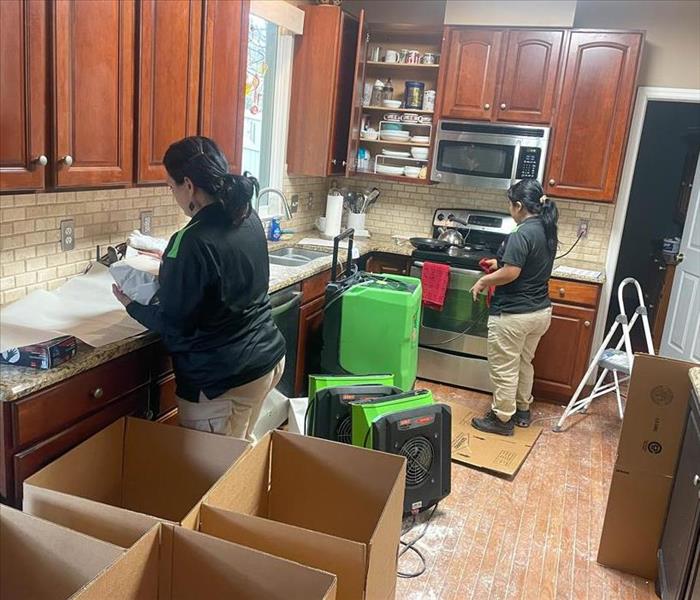 SERVPRO team cleaning and packing contents
