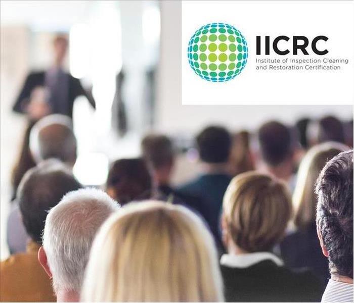 People receiving training. Logo IICRC