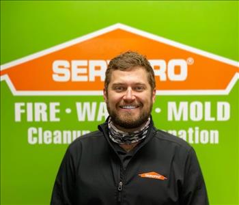 Man in front of SERVPRO logo
